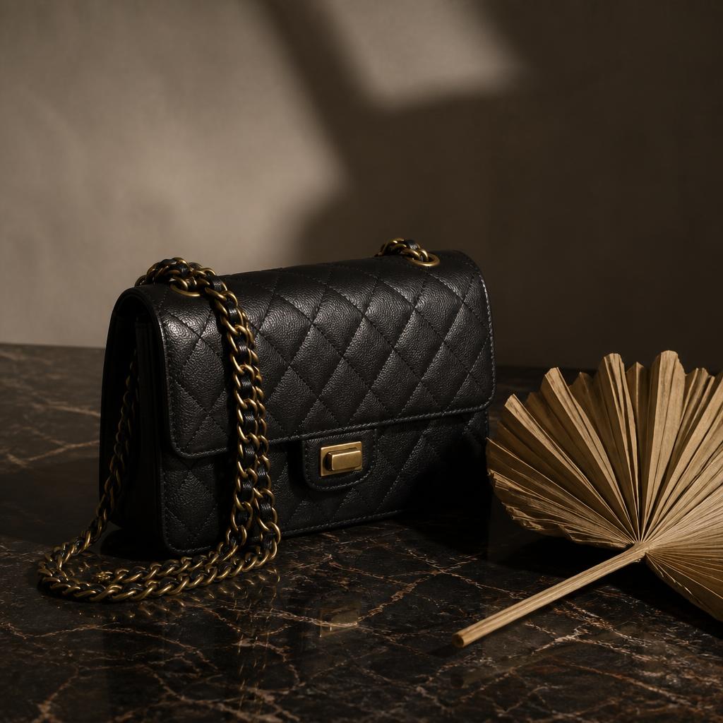 Quilted black leather designer handbag with gold chain
